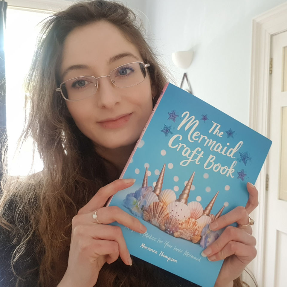 Author Image Holding The Mermaid Craft Book